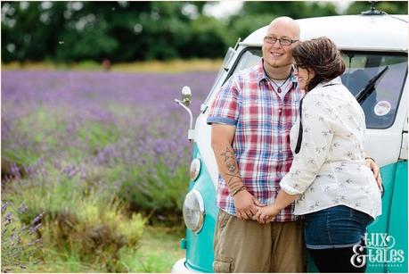 Couple cuddle in front of VW camper van in UK lavender field mayfield 