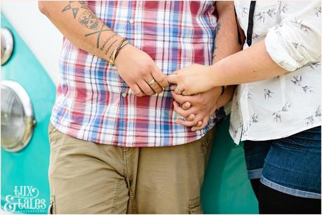 Tattooed rocker couple hold hands in UK engagement shoot he is wearing a checked shirt