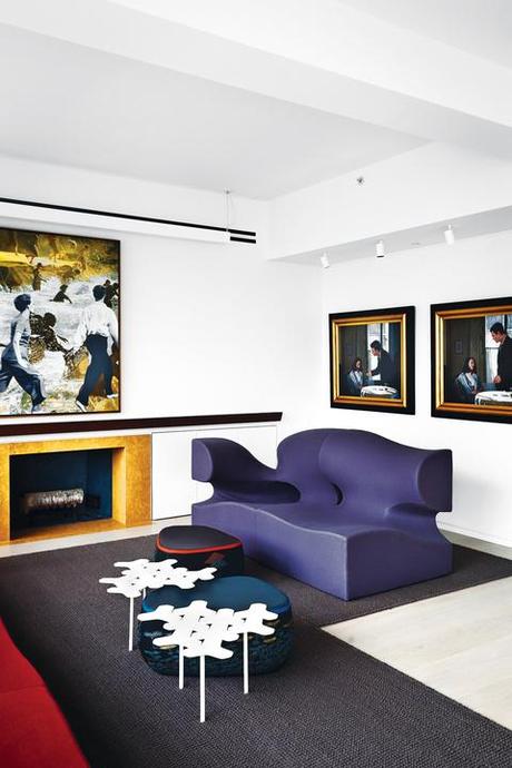 Modern living room with purple sofa and artwork