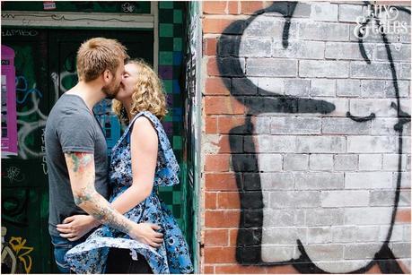 Couple kiss in front of graffiti wall in sheffiled UK