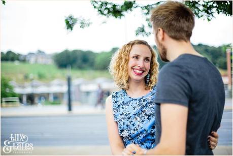 Engagement shoot pose with bride smiling at groom 