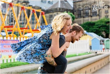 Girl laughs loudly in funn protrait giving piggyback ride at Sheffield summer bach 