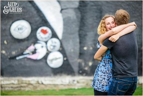 Couple hug in front of mural wall in sheffield Workshire UK 