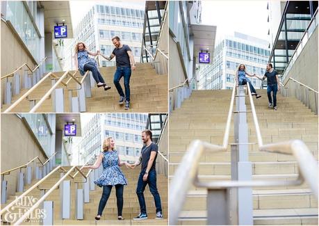 Fun engagement shoot pose of couple sliding down banister in Sheffiled UK Yorkshire