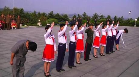 Members of the Kim Il Sung Socialist Youth League and Young Red Guards salute Kim Jong Suk's memorial bust in Pyongyang on 22 September 2013 (Photo: KCNA screengrab).