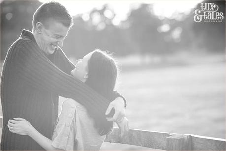 Laughing engaged couple embraces at Stockeld Park 