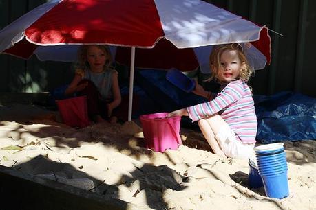The girls add a beach umbrella 