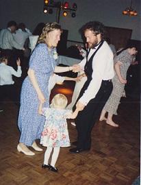 parents dancing with little daughter