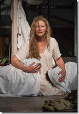 Beatriz (ensemble member Joan Allen) embraces two familiar dead bodies in Steppenwolf Theatre Company’s American-premiere production of The Wheel by Zinnie Harris, directed by ensemble member Tina Landau.  (photo credit: Michael Brosilow)