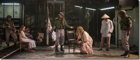 Glennister (ensemble member Tim Hopper, center) insists that Beatriz (ensemble member Joan Allen, center right) must prove that The Girl is miraculous as (left to right) a soldier (Kareem Bandealy), The Girl (Emma Gordon), The Boy (Daniel Pass), Xuan (Demetrios Troy) and Hancock (La Shawn Banks) look on in Steppenwolf Theatre Company’s American-premiere production of The Wheel by Zinnie Harris, directed by ensemble member Tina Landau.  (photo credit: Michael Brosilow)