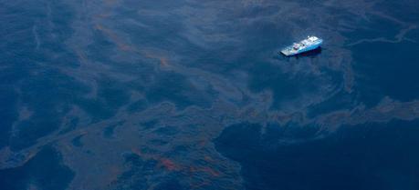 A ship floats amongst a sea of spilled oil in the Gulf of Mexico after the BP Deepwater Horizon disaster. (Credit: Flickr @ kris krüg http://www.flickr.com/photos/kk/)