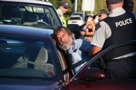 Greg Cook gets roughed up by RCMP. Photo: Miles Howe