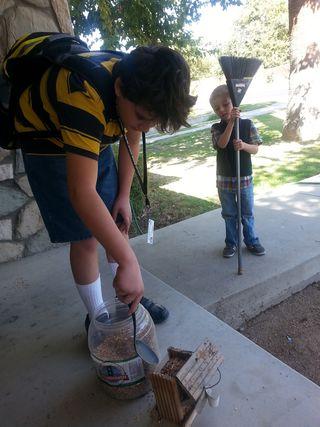 The boys took turns filling the bird feeder