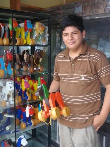 A participant in the EmprendeAhora youth entrepreneurship program in Peru shows off his products.