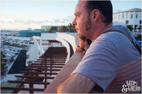 Man and boy look at Lanzarote sunset from balcony at Sandos Papagayo 