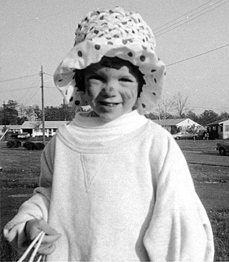 little girl in floppy hat and oversized sweatshirt