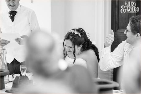 Bride laughs during speeches at Woburn Abbey 