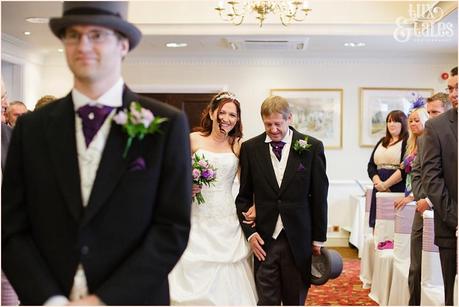 Groom in top hat as bride walks up the aisle at Woburn Abbey 