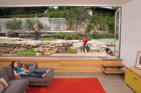 Modern family room with extended window and small staircase 