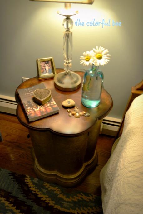 a nightsand with mementos in a bedroom