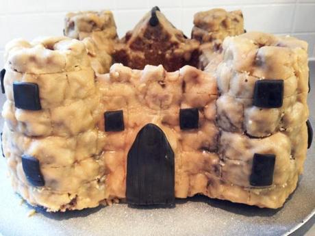 rear of malory towers castle cake back door and windows made out of black chocolate foundant caramel icing