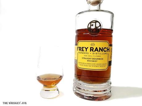 Frey Ranch Bourbon Review White background tasting shot with the Frey Ranch Bourbon bottle and a glass of whiskey next to it.