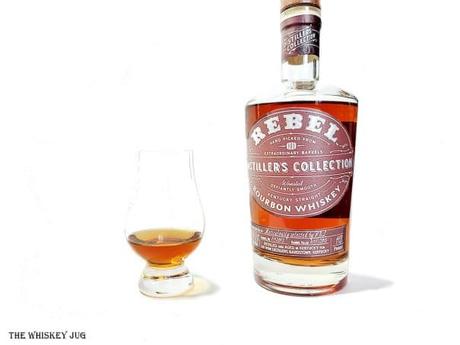 White background tasting shot with the Rebel Yell Distiller's Collection Bourbon bottle and a glass of whiskey next to it.