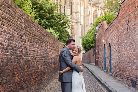 Bride and groom pose of photos outside of Grays Court with the Minster in the background
