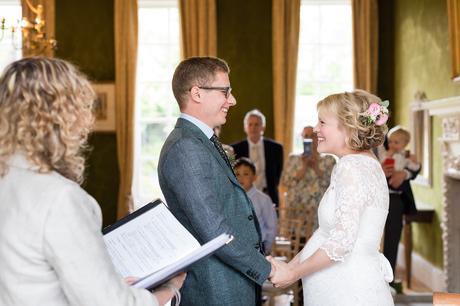Bride and groom smiling at each other during Grays Court wedding ceremony
