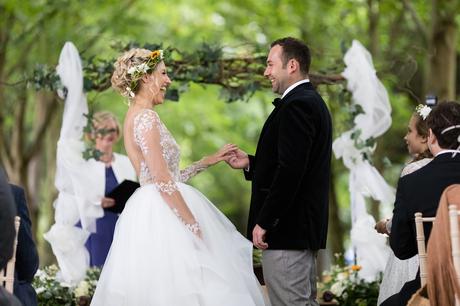 Bride in flower crown exchanging rings