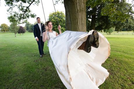 Groom pushes bride on swing - bride wears riding boots