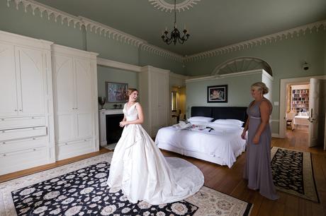 Bride in beautiful stately home gets dressed into her Ian Stuart wedding dress