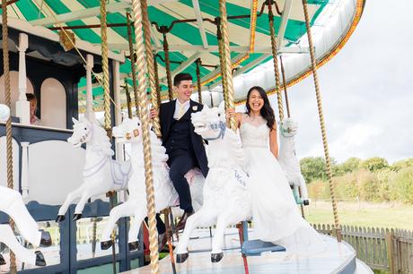 Happy bride and groom ride a carousel at Preston Court Wedding