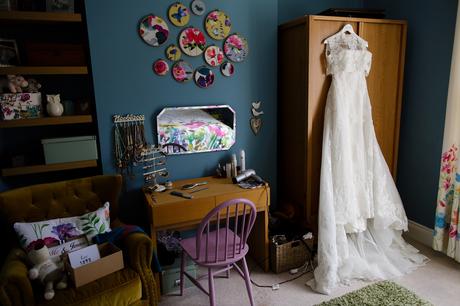 Beautiful wedding dress in a room with teal walls