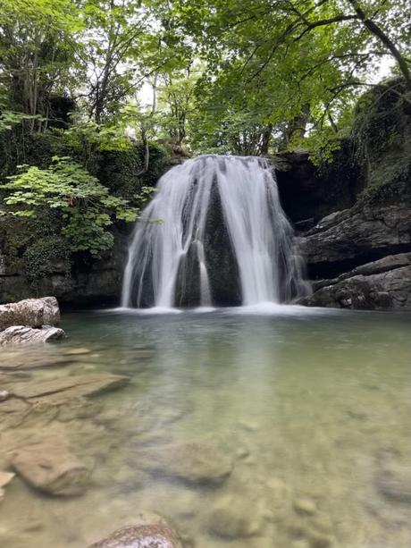 A group hiking meeting up in the Yorkshire Dales using the Hiiker app A waterfall in a forest
Description automatically generated with medium confidence