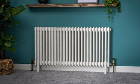 traditional white column radiator on a blue wall