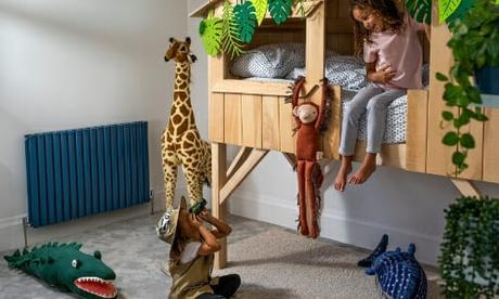 two children in a bedroom with a blue radiator