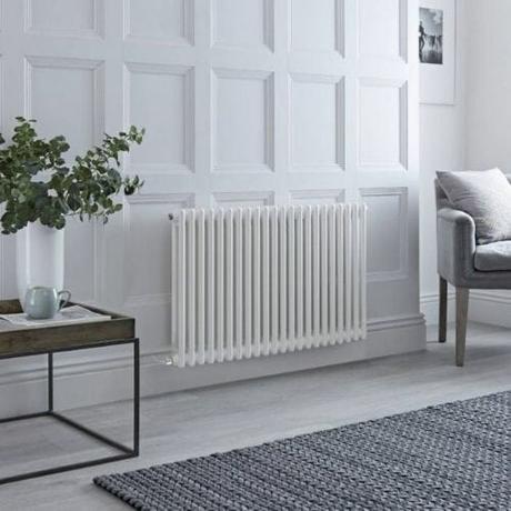 milano windsor electric column radiator in a gray living room