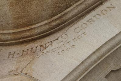 Photograph showing a carved detail: the name 'H Huntley Gordon, Architect'