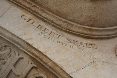 Photograph showing a carved detail: the name 'Gilbert Seale, Sculptor'