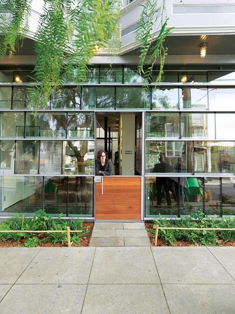 Storefront facade with salvaged double-insulated window glass panels