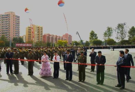 Senor DPRK officials hold a ceremonial red ribbon being cut by representatives of Pyongyang's population during a ceremony opening the Munsu Water Park in east Pyongyang on 15 October 2013 (Photo: Rodong Sinmun).