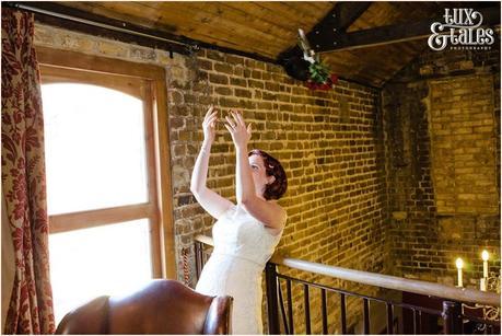 Bride throws a bouquet over a balcony at London wedding