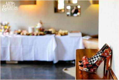 red and black shoes with a DIY wedding int he background