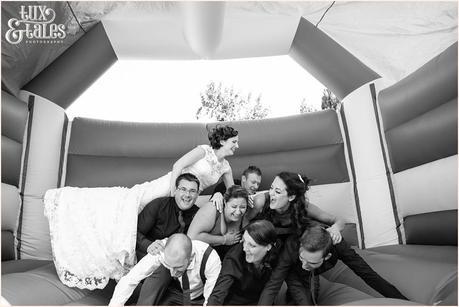 Bride jumps on top of human pyramid in bouncy castle