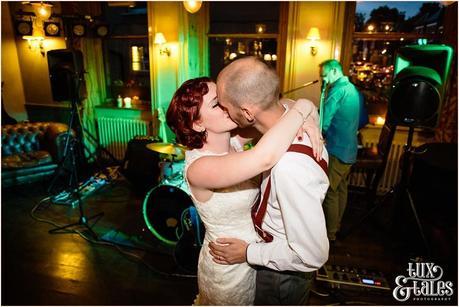 Alternative couple kiss at wedding dance