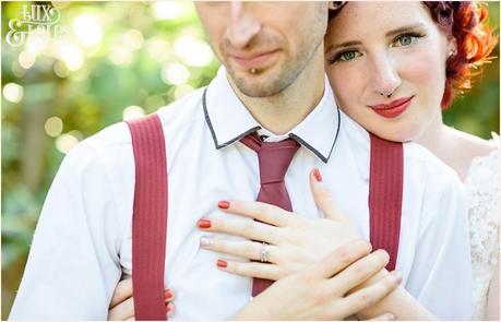 Tattooed pierced bride and groom embrace at London wedding showing off wedding ring