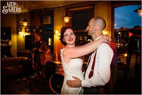 redheaded bride dances with alternative styled groom