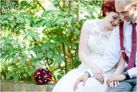 Tattooed bride wearing lace dress embraces groom at London wedding 