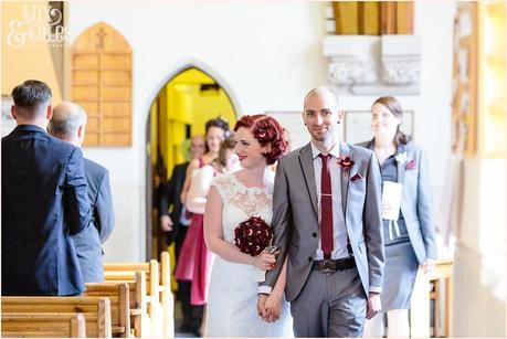 Bride with red heair walks back up aisle